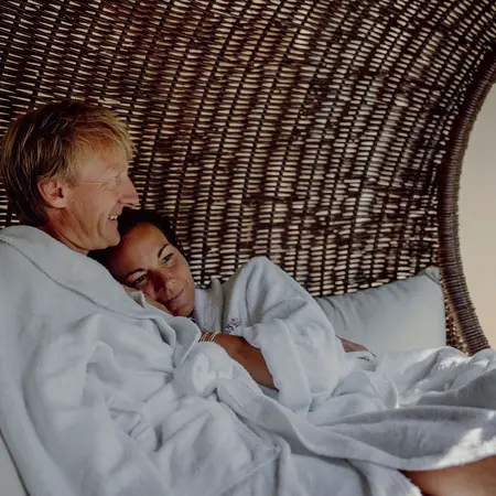 Couple in white bathrobes in the wellness relaxation area
