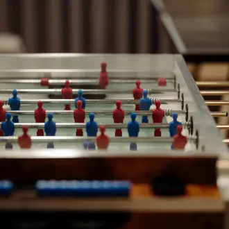 Tischfußball mit roten und blauen Spielfiguren