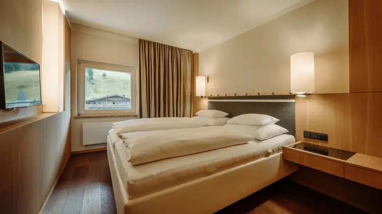 Hotelzimmer mit Doppelbett, Fenster und Blick ins Grüne
